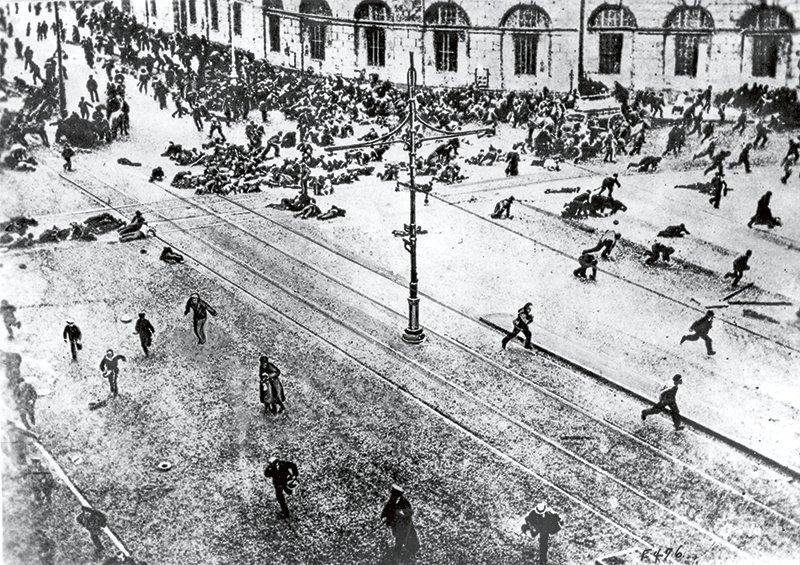 FILE - In this May 1917 file photo, a scene on the main street in St. Petersburg, Russia, (during communist times called Petrograd), during the revolution when the revolutionists turned on their machine guns. The tumult that Russia endured in 1917 sent shockwaves around the world as its last czar, Nicholas II, abdicated his throne, and power was later seized by Vladimir Lenin‚Äôs Bolsheviks. A century later, the anniversary is being marked with little official commemoration from the Kremlin. (AP Photo, File)