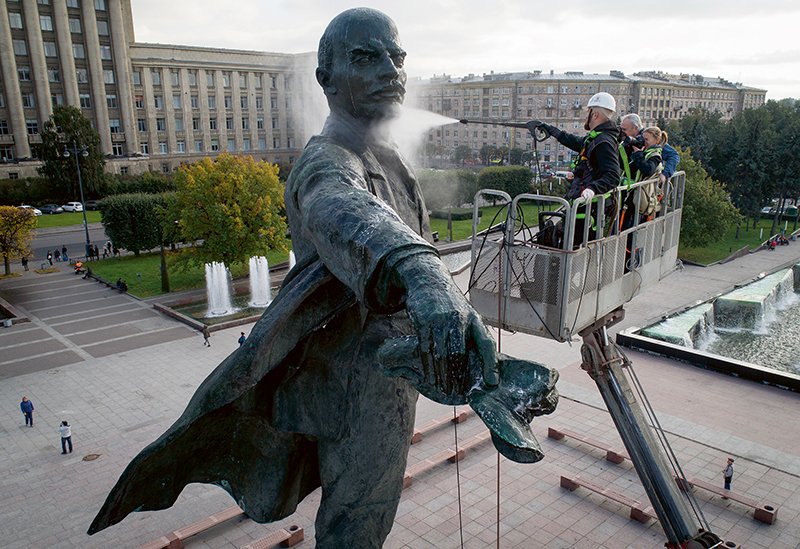 A worker washes a statue of Soviet Union founder Vladimir Lenin in St.Petersburg, Russia, Thursday, Sept. 28, 2017. On Nov. 7, 2017 some Russians will commemorate 100 years of Bolshevik Revolution. (AP Photo/Dmitri Lovetsky)