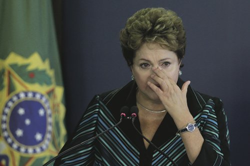 Brazil's President Dilma Rousseff cries during a speech at the launching ceremony of the National Truth Commission Report, at the Planalto Presidential Palace, in Brasilia, Brazil, Wednesday, Dec. 10, 2014. Brazil's National Truth Commission delivered a damning report on the killings, disappearances and acts of torture committed by government agents during the country's 1964-1985 military dictatorship. It called for those responsible to face prosecution. (AP Photo/Eraldo Peres)