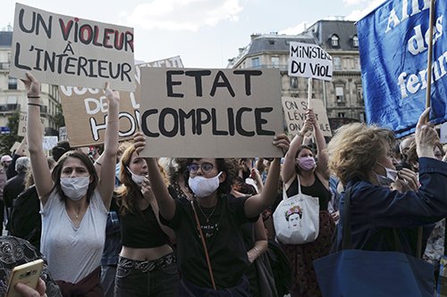 Women's rights activists protest against French President Emmanuel Macron's appointment of an interior minister who has been accused of rape and a justice minister who has criticized the #MeToo movement, in front of Paris city hall, in Paris, France, Friday, July 10, 2020. The French government said it remains committed to gender equality and defended the new ministers, stressing the presumption of innocence. Gerald Darmanin, Interior Minister, firmly denies the rape accusation, and an investigation is underway. New Justice Minister Eric Dupond-Moretti is a lawyer who has defended a government member accused of rape and sexual assault, and has ridiculed women speaking out thanks to the #MeToo movement. (AP Photo/Francois Mori) XFM126
