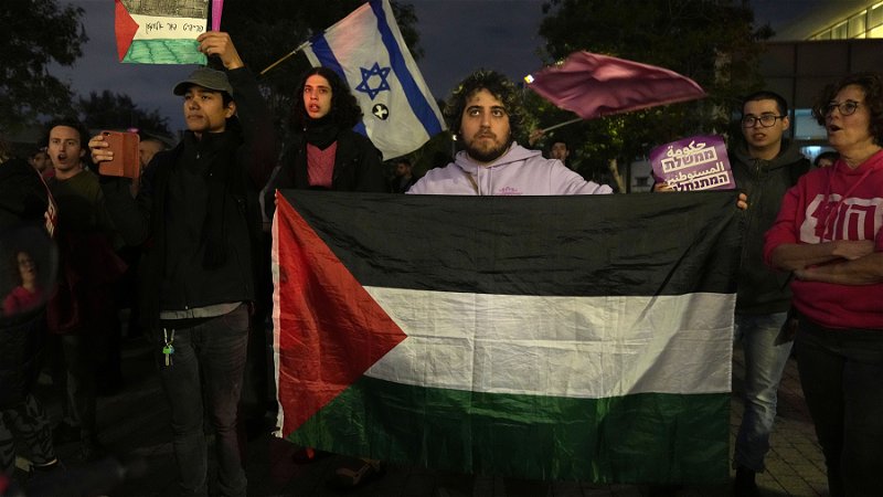 Både israeliska och palestinska flaggor syntes på en demonstration mot premiärminister Benjamin Netanyahu i januari. Foto: Tsafrir Abayov/AP.

