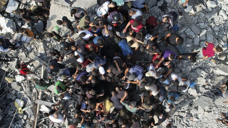 Palestinier letar efter överlevare efter den israeliska bombningen 
av flyktinglägret Maghazi på Gazaremsan den 5 november. Foto: Hatem Moussa/AP.